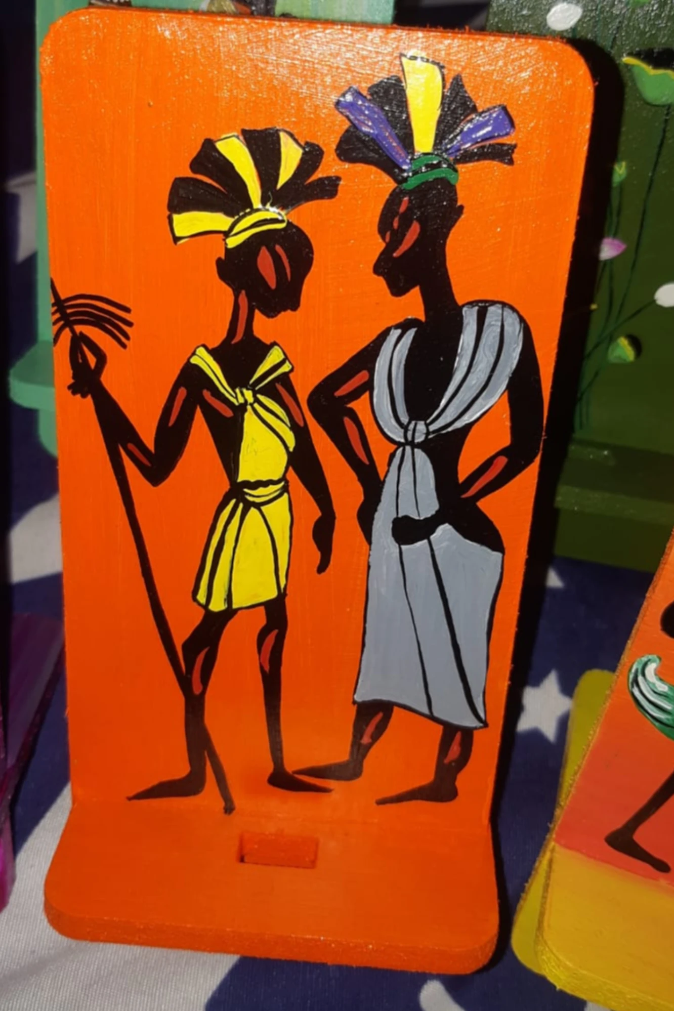 Tribal Couple Themed In Colour Orange Mobile Stand