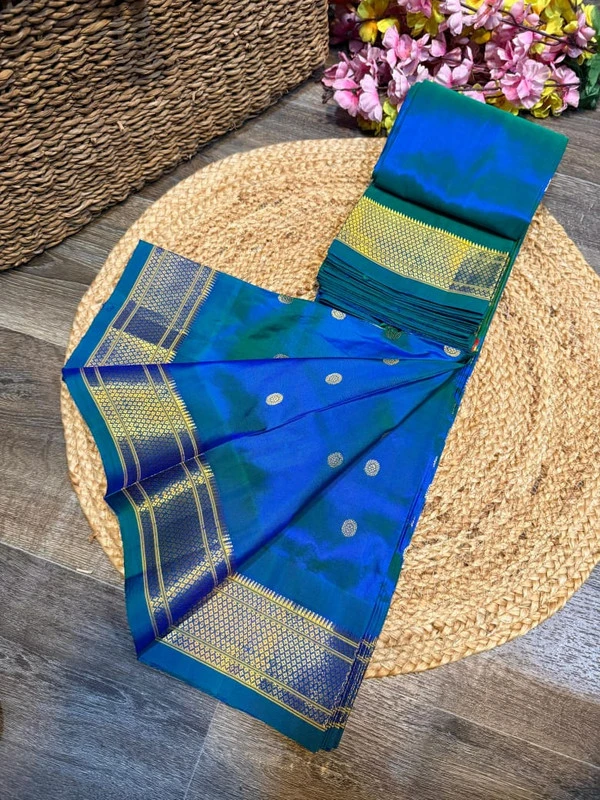 Exclusive Blue Green Paithani self color pure silk saree with gold zari border, traditional Meena butta weaving and handwoven craftsmanship.