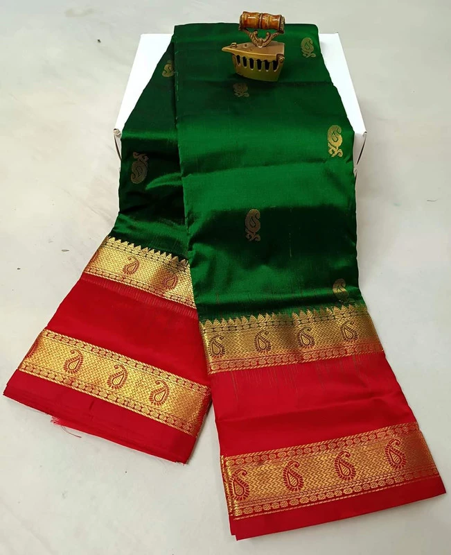 Green silk saree with red and gold Bentex border featuring paisley and temple motifs.