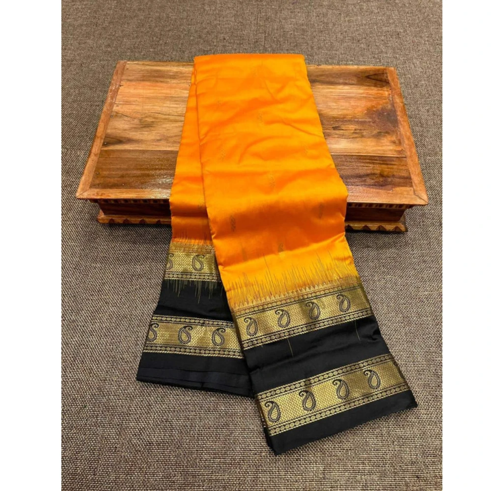 Orange Kanchipuram silk saree with black Bentex border and gold paisley motifs.