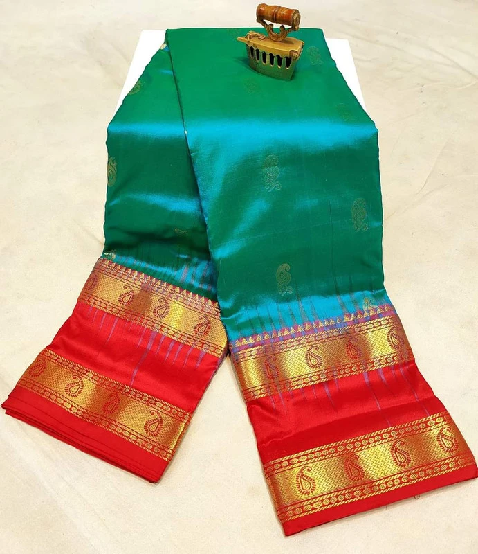 Forest green silk saree with red and Bentex gold border and paisley motifs.