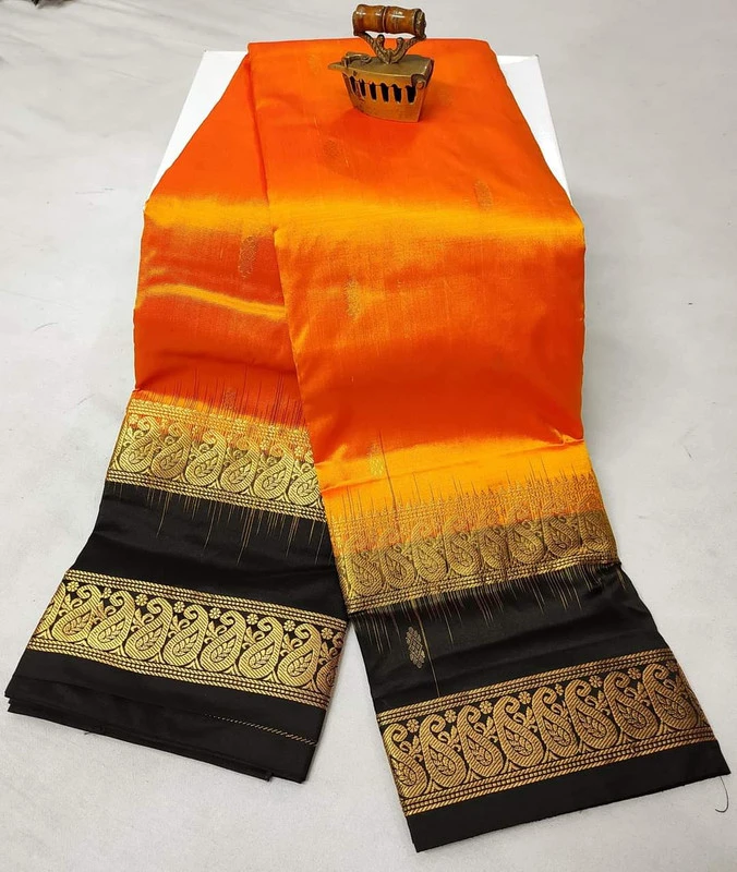 Orange silk saree with black and gold Bentex border, floral and paisley designs.