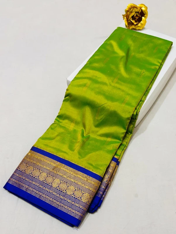 Light green Kanchipuram silk saree with blue and gold zari border