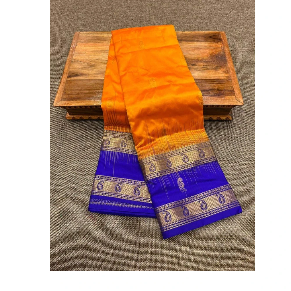 Orange silk saree with royal blue Bentex border and traditional paisley motifs.