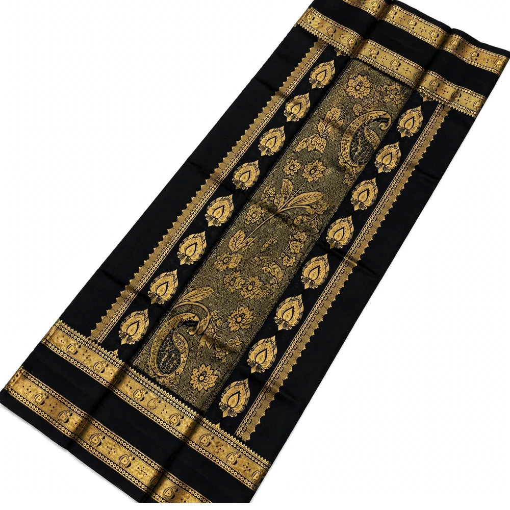 Emerald green silk saree with black and gold Bentex border and paisley motifs.