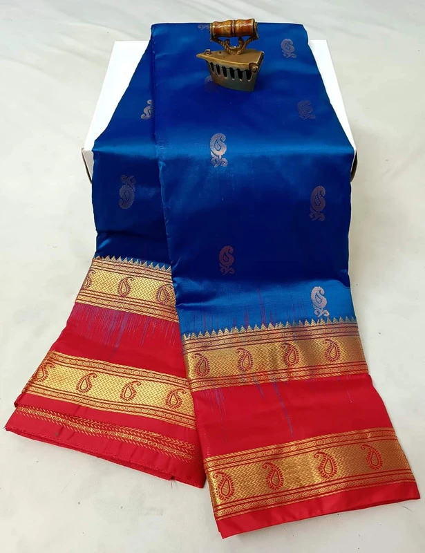 Deep navy blue silk saree with yellow and gold Bentex border, paisley woven.