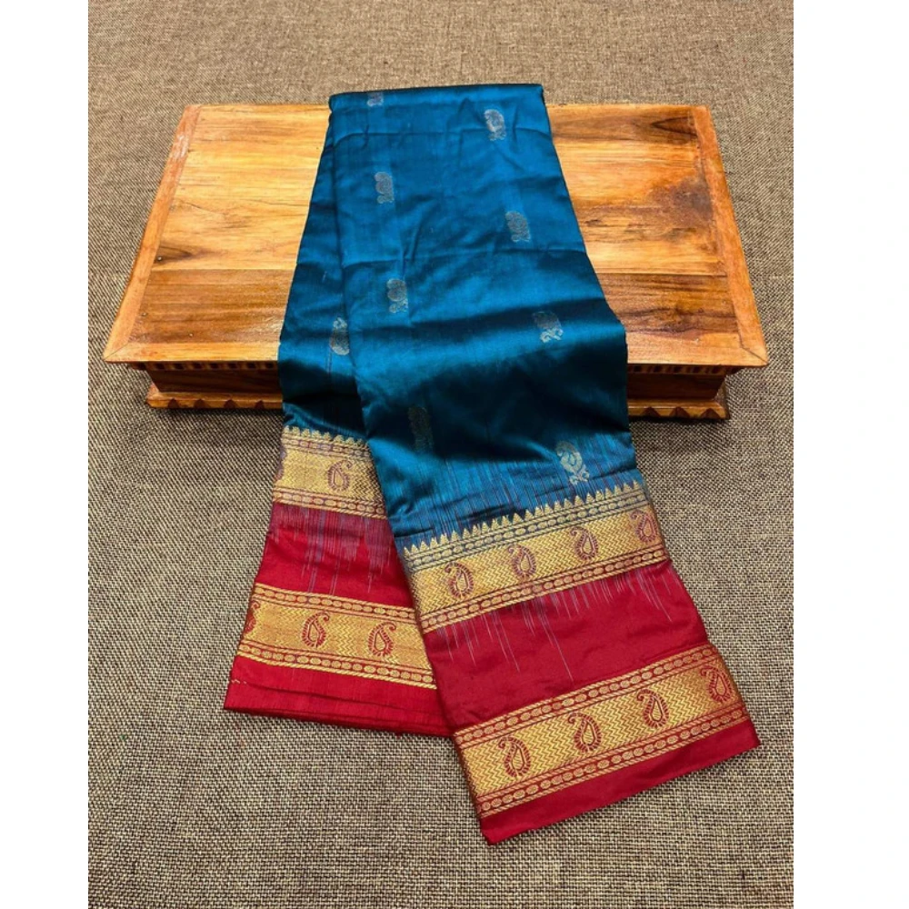 Teal blue silk saree with red Bentex border and gold paisley motifs.