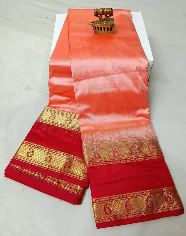 Peach-orange silk saree with red and gold Bentex border and paisley motifs.
