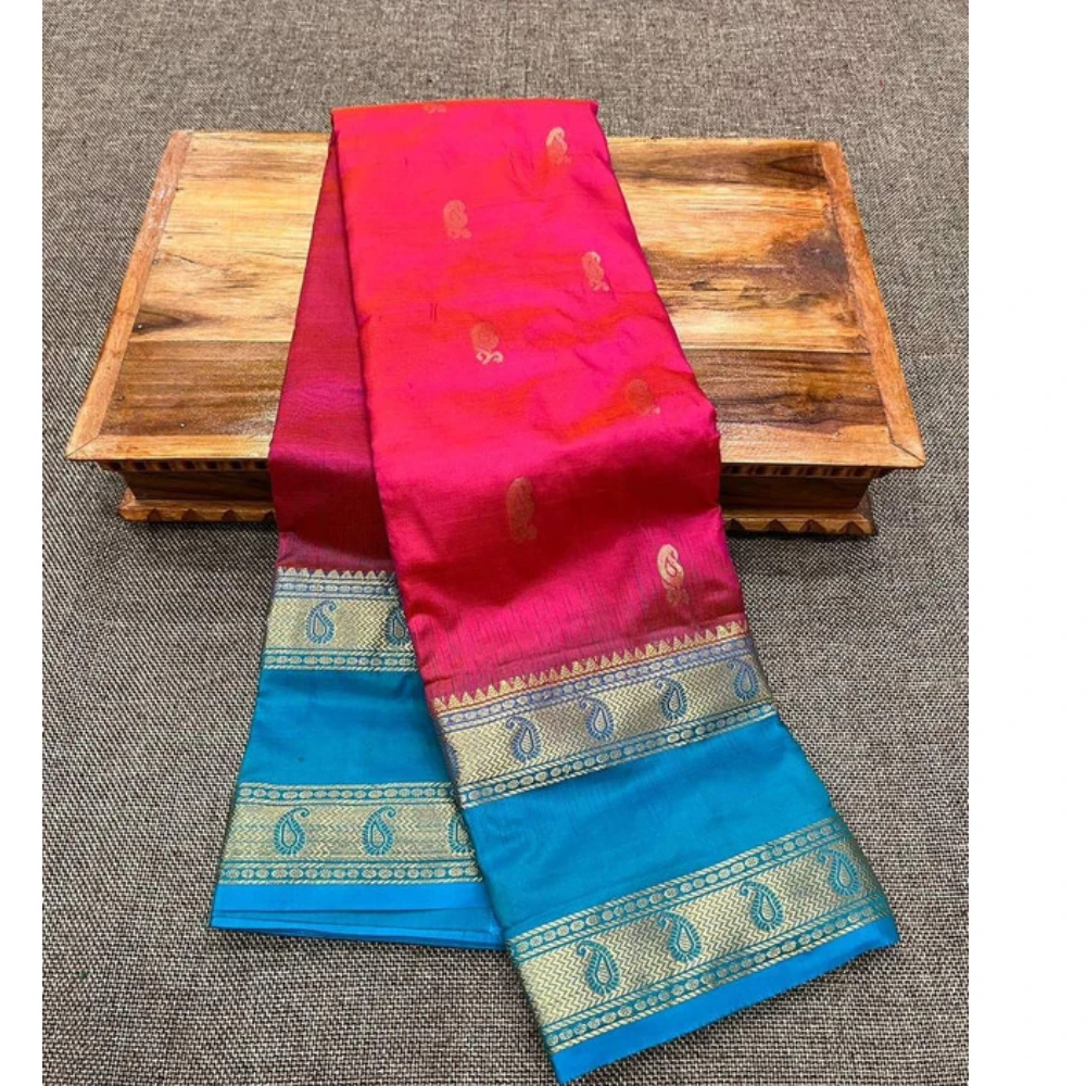 Rani pink Kanchipuram silk saree with blue Bentex border and gold paisley motifs.
