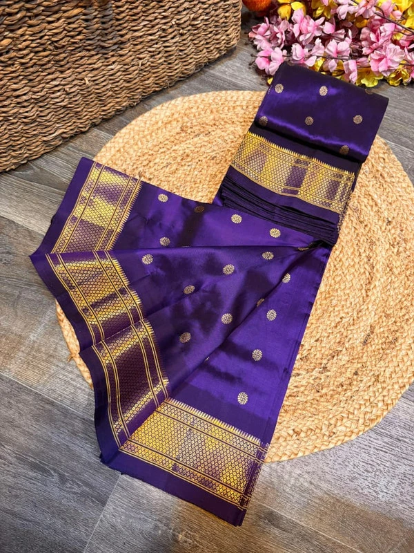 Exclusive Navy Blue Paithani self color pure silk saree with gold zari border, traditional Meena butta weaving and handwoven craftsmanship.