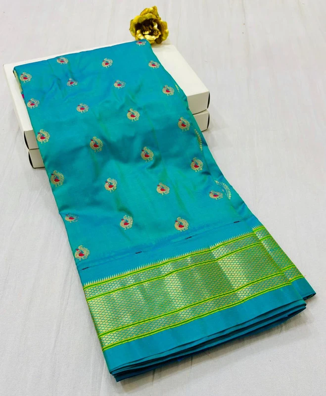 Exclusive Turquoise Blue Paithani self color pure silk saree with gold zari border, traditional Meena butta weaving and handwoven craftsmanship.