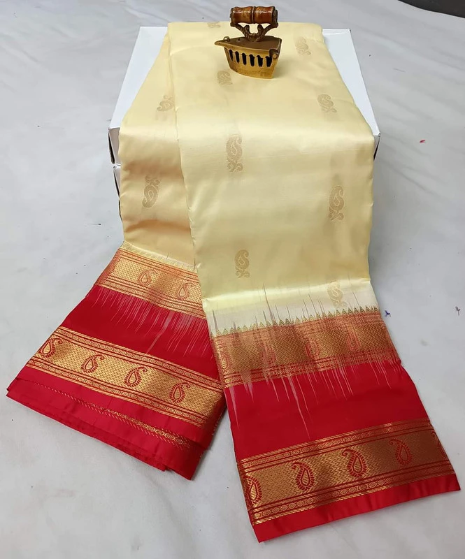Off white  Kanchipuram silk saree with gold and red Bentex border, paisley details.