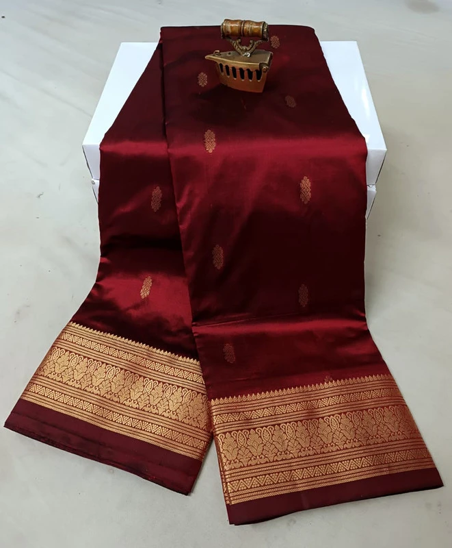 Magenta traditional silk saree with zari border for festive and wedding occasions