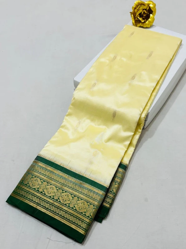 Cream Kanchipuram pure silk saree with Green and Gold zari border, traditional Indian wedding saree