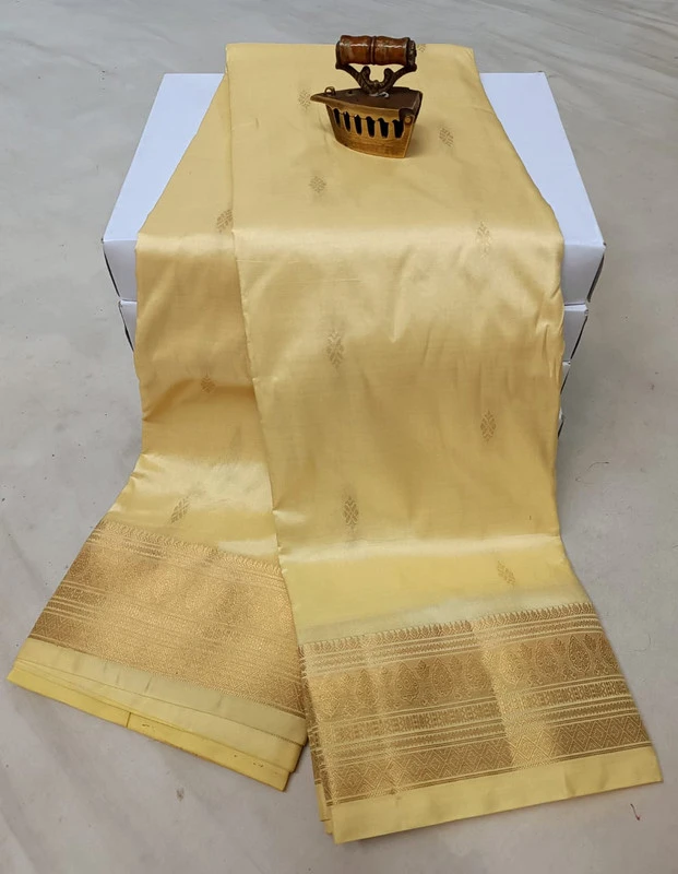 Cream traditional silk saree with zari border for wedding and festive wear